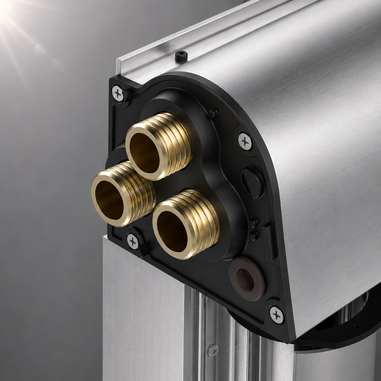 2F4CE2D6-6A8A-4644-B54C-C6B707CA3132 - Pleion Close-up of a metallic actuator housing with three brass threaded fittings mounted on a black circular plate on a brushed aluminum frame.
