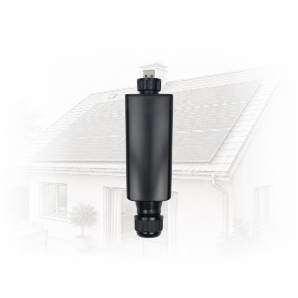 Close-up of a black cylindrical outdoor device mounted on a pole in front of a house with solar panels on the roof.