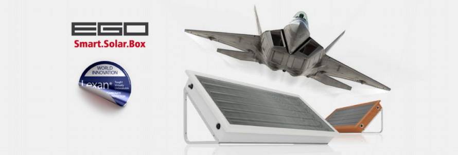 ESO Smart.Solar.Box logo with a blue World Innovation Lexan badge, a model fighter jet flying over a tilted solar panel on a stand and an orange accessory to the side.